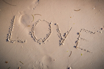 Love written on beach sand