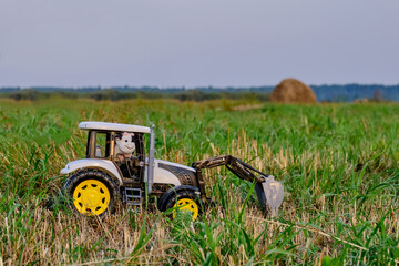 Toy tractor with toy tractor driver cow
