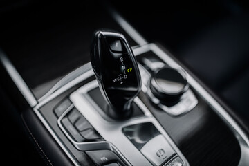 Modern and expensive car interior and gearbox shift handle 