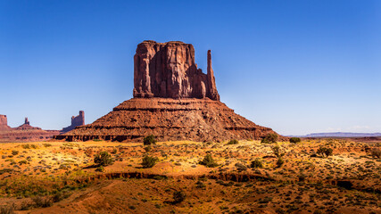 Fototapeta na wymiar The towering red sandstone formation of West Mitten Butte in the Navajo Nation's Monument Valley Navajo Tribal Park on the border of Arizona and Utah, United States