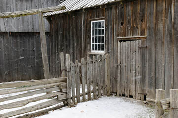 Fototapeta na wymiar Outside of Edgeley slaughter house 1860 in winter snow at Black Creek Pioneer Village Toronto