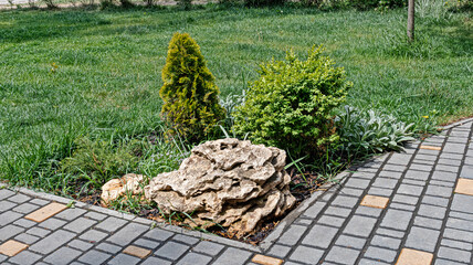 A Miniature Stylized Alpine Slide Formed by A Block of Sandstone and Decorated with Green Plants in One of the Park Areas
