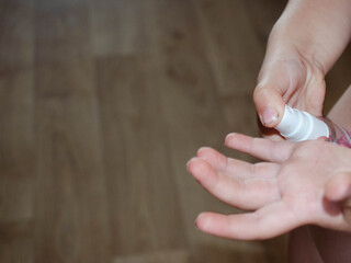 The hands of a small child. Disinfection of the palms.