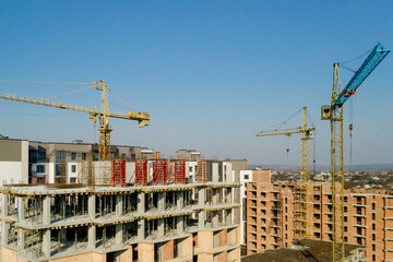 Construction and construction of high-rise buildings, the construction industry with working equipment and workers. View from above, from above. Background and texture