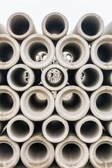 Group of concrete sewer pipes stacked at factory