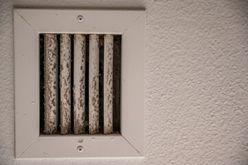 Obraz na płótnie Canvas Subjective focus on lint and dirt particles on a ceiling air vent