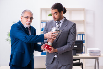 Two male employees working in the office