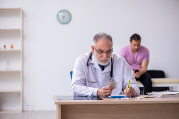 Young male patient visiting old male doctor