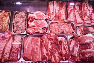 Counter with cold raw meat products. Fresh and pink meat packs. Meat market. Different and quality...