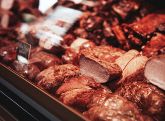 Close up of smoked brown meat. Fresh and deli product. Meat shop business.