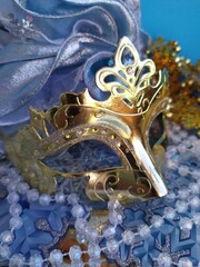 Gold carnival mask on a blue and gold christmas background