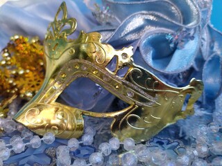 Gold carnival mask on a blue and gold christmas background