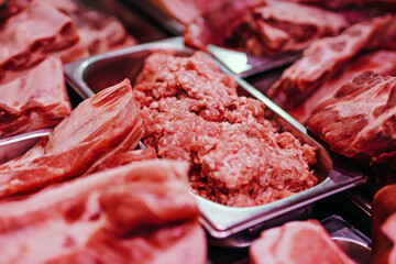 Counter with cold raw meat products. Fresh and pink meat packs. Meat market. Different and quality product in fridgerator.