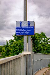 COVID social distance sign on fence