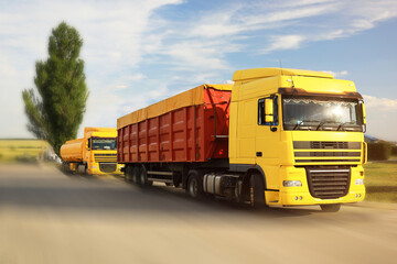 Fototapeta na wymiar Logistics concept. Trucks on country road, motion blur effect