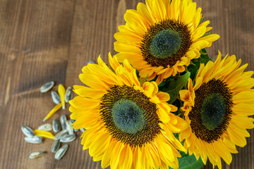 Vivid sunflower bouquet closeup on the wooden background.