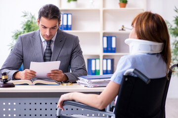 Young injured woman and male lawyer in the courtroom