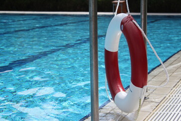 big empty swimming pool in summer with lifebuoy