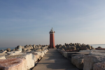 rocky path to lighthouse at the coast