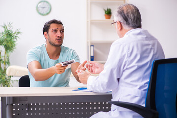 Young male patient visiting experienced doctor