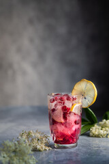Pink elderberry drink with pomegranate and lemon. Fresh pink summer lemonade.