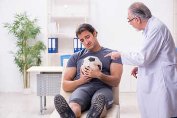 Young injured soccer player visiting old doctor traumatologist