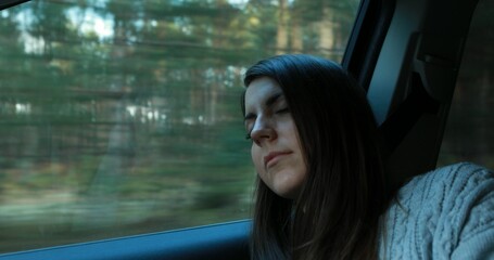 Fototapeta na wymiar Pretty young woman sleeping in car