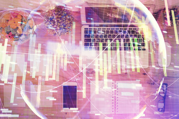 Business theme hologram drawings over computer on the desktop background. Top view. Multi exposure. Concept of international connections.