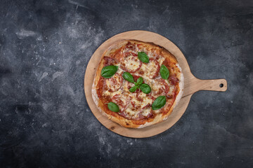 Sliced pizza on dark background