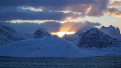 Cold snow winter landscapes with dominant Volandstind Peak during sunset at Fredvang, Lofoten,...