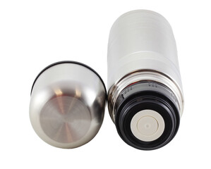 Stainless steel thermos lies isolated on a white background. It can be used for hot tea or coffee. The lid is unscrewed. It serves as a mug.