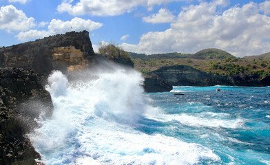 Indic sea waves hitting the cliff rocks at Angel’s Billabong point, an amazing spot close to Broken beach in Nusa Penida Island, Indonesia.