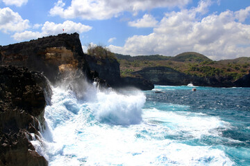 Indic sea waves hitting the cliff rocks at Angel’s Billabong point, an amazing spot close to Broken beach in Nusa Penida Island, Indonesia.