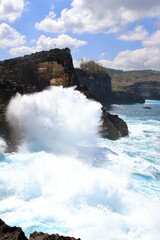 Indic sea waves hitting the cliff rocks at Angel’s Billabong point, an amazing spot close to Broken beach in Nusa Penida Island, Indonesia.