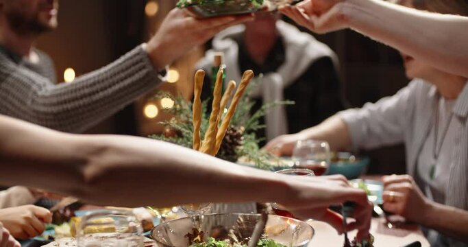 Happy family celebrating christmas at home. Family members together at holiday dinner table talking, smiling and eating - celebration, real people 4k footage