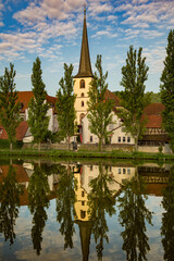 A church on the bank of the Main River with a perfect reflection, at Baden-Wurttemberg, Germany