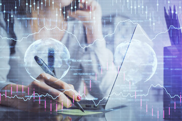 Double exposure of woman hands typing on computer and financial graph hologram drawing. Stock market analysis concept.