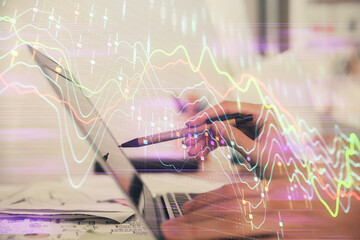 Multi exposure of woman hands typing on computer and financial graph hologram drawing. Stock market analysis concept.