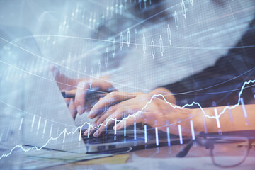 Multi exposure of woman hands typing on computer and financial graph hologram drawing. Stock market analysis concept.