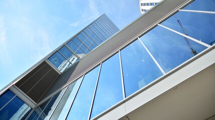 Bottom view of glass silhouette of skyscraper. Business building. Skyscraper with glass facade. Modern building in business district. Concepts of economics, financial, future.   