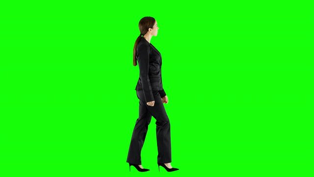 Serious Female Business Owner Walking Down a Hallway Controlling Her Staff