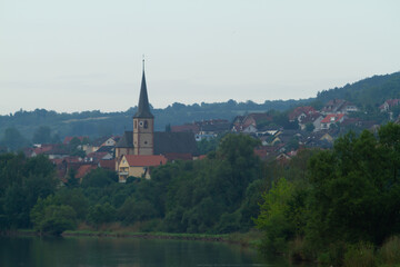 Obraz premium A church in a residential area on the bank of the Main River in Baden-Wurttemberg, Germany