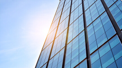 Bottom view of glass silhouette of skyscraper. Business building. Skyscraper with glass facade. Modern building in business district. Concepts of economics, financial, future.   