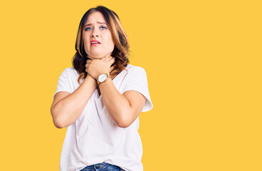 Young beautiful caucasian woman wearing casual white tshirt shouting suffocate because painful strangle. health problem. asphyxiate and suicide concept.