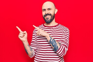 Naklejka premium Young handsome man wearing casual clothes smiling and looking at the camera pointing with two hands and fingers to the side.