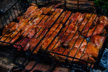 barbecue is prepared on the grill. Smoke from the fire
