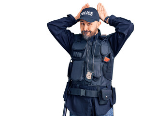 Fototapeta premium Young handsome man wearing police uniform doing bunny ears gesture with hands palms looking cynical and skeptical. easter rabbit concept.