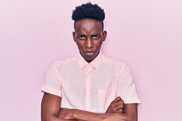 Obraz premium Young african american man wearing casual clothes skeptic and nervous, disapproving expression on face with crossed arms. negative person.