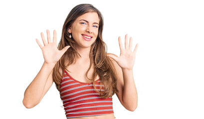 Beautiful caucasian young woman wearing casual clothes showing and pointing up with fingers number ten while smiling confident and happy.