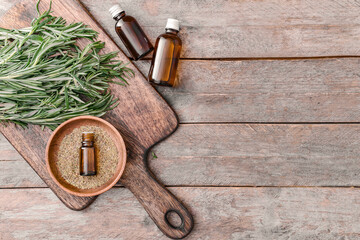 Bottles of rosemary essential oil on table